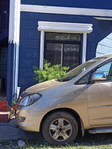 a car parked in front of a house at Holiday home in Ooty