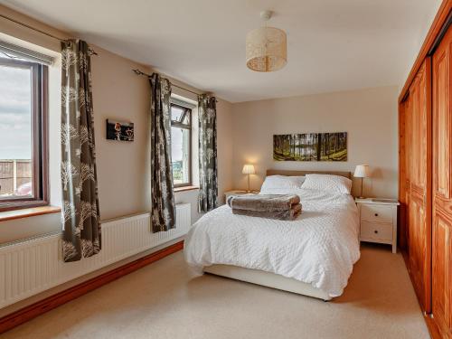 a bedroom with a bed and a window at 1 Bed in St Briavels 73584 in Saint Briavels