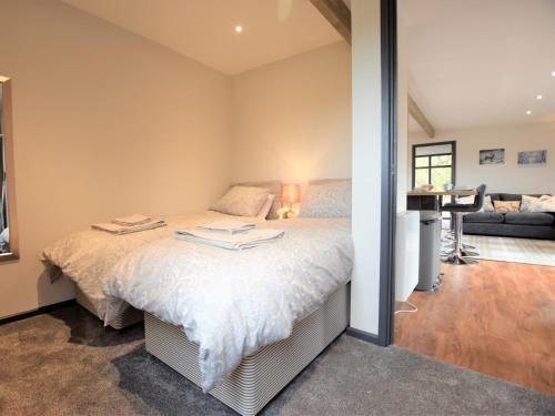 a bedroom with a bed and a living room at 2 Bed in Thetford 73624 in East Harling