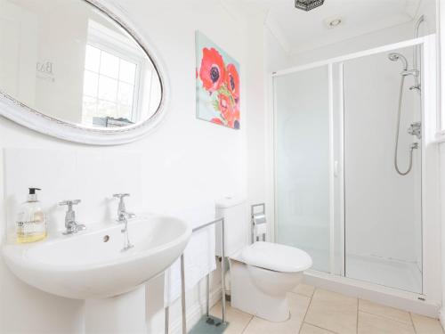 a white bathroom with a sink and a shower at 1 Bed in Edzell CA217 in Edzell