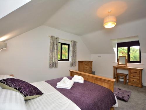a bedroom with a bed with towels on it at 4 Bed in Conwy 66510 in Llanrwst