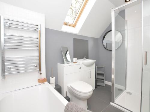 a bathroom with a white toilet and a shower at 2 Bed in Tansley 78219 in Tansley
