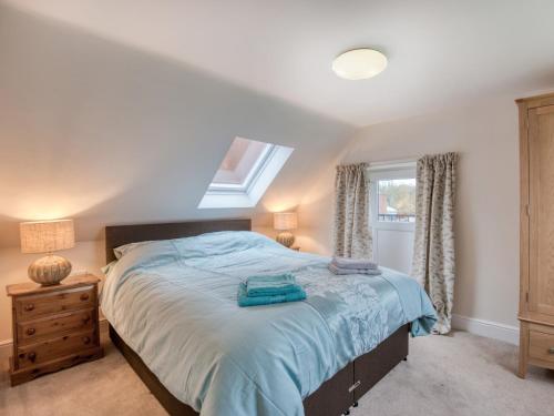 a bedroom with a large bed and a window at 1 bed property in Godshill 77796 in Downton