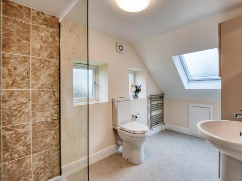 a bathroom with a toilet and a sink at 1 bed property in Godshill 77796 in Downton