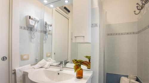 a white bathroom with a sink and a mirror at PROFUMO DI ZAGARA 6&2 Emma Villas in Ispica
