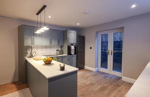 a kitchen with a island in the middle of a room at Sunshine 2 Bed Townhouse Brighton in Brighton & Hove