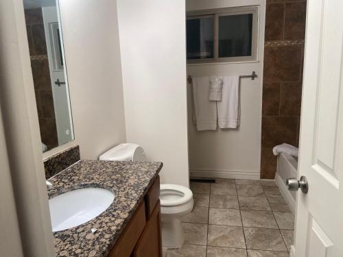 a bathroom with a sink and a toilet at Cozy retreat in Salt Lake City