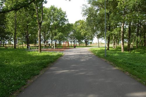 a path in a park with trees and grass at Kate Sea Apartment in Pärnu