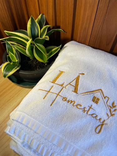a napkin with the word pharmacy on it next to a plant at Lá Garden Homestay in Long Xuyên