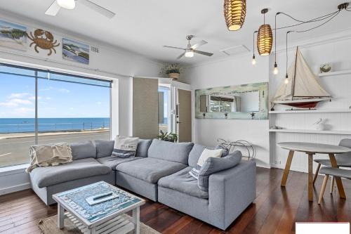 a living room with a couch and a table at sea forever in Port Vincent