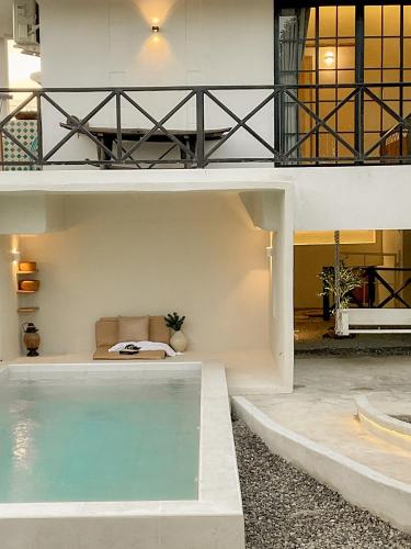 a house with a swimming pool in the middle at Compass North - PoolVilla & BBQ in Ban Pa Lan