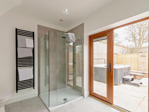a bathroom with a shower and a glass door at 1 Bed in Filey 79277 in Wold Newton