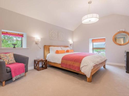 a large bedroom with a bed and a chair at 2 Bed in Kirkby Lonsdale SZ093 in Kirkby Lonsdale