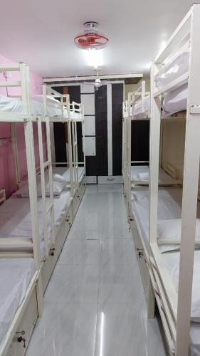 a room with several bunk beds in a room at BASERA HOSTEL DORMITORY in Alambagh