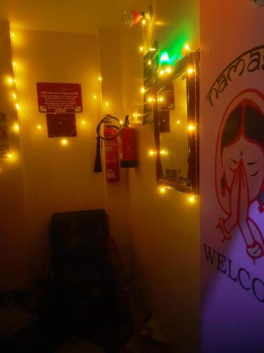 a room with christmas lights on the wall at BASERA HOSTEL DORMITORY in Alambagh