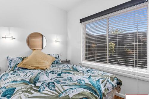 a bedroom with a bed and a window at crystal blue apartment in Port Vincent