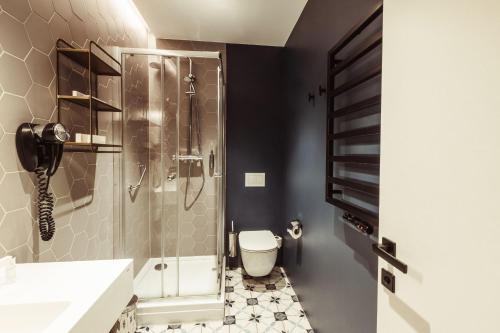 a bathroom with a shower and a toilet at Konventa Sēta Hotel Keystone Collection in Rīga