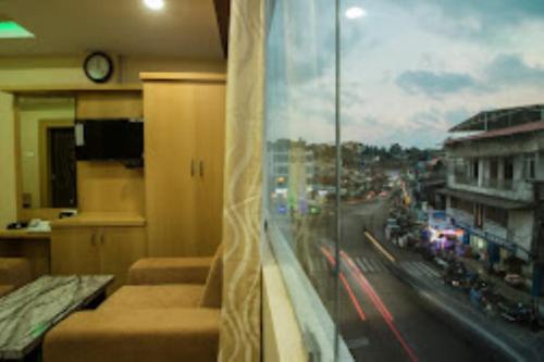 a room with a window with a view of a city at CITY VIEW, Port Blair in Port Blair