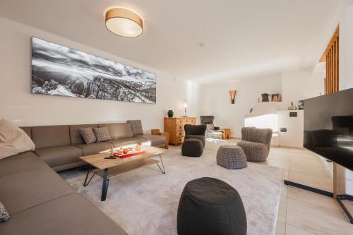 a living room with a couch and a table at Löwen Chalets in Seefeld in Tirol