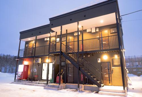 a apartment building with a balcony on the side of it at Niseko Hirafu Ski Resort Condo in Kutchan