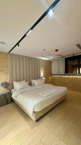 a bedroom with a large white bed in it at Damac Jeddah 1408 in Jeddah