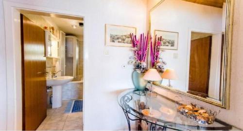 a bathroom with a glass table and a mirror at Seaside Lux in Dugi Rat