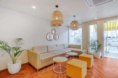 a living room with a couch and two tables at Bloom Hotel - Karol Bagh in New Delhi