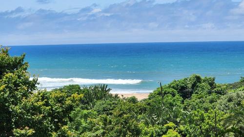 a view of a beach with trees and the ocean at Seaview Villa 26 in Margate