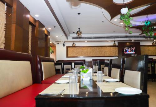 a dining room with a long table and chairs at The Vaishnavi in Deoghar