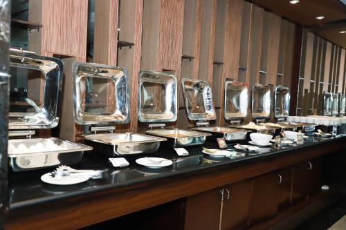 a row of sinks in a public restroom at The Vaishnavi in Deoghar