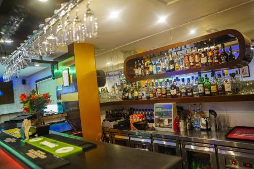 a bar with a lot of bottles of alcohol at The Vaishnavi in Deoghar