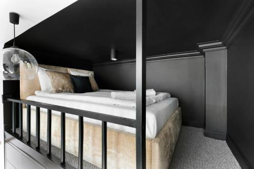 a bedroom with a bed with a black ceiling at Old Town Premium by Elite Apartments in Gdańsk