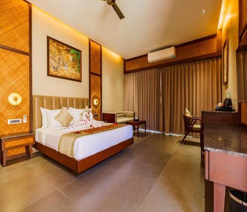 a hotel room with a bed and a desk at Sajjan Bagh Resort Kumbhalgarh in Kumbhalgarh