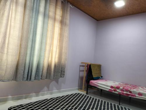 a room with a bed and a window at Nik Homestay in Tanah Merah