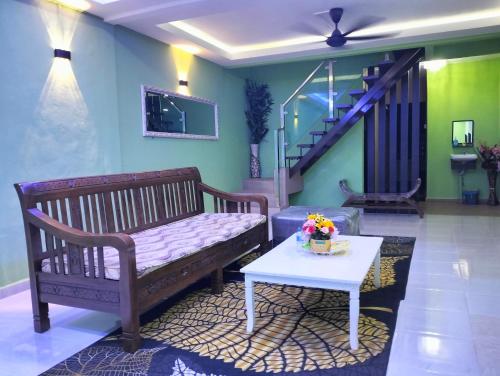 a living room with a bench and a table at Nik Homestay in Tanah Merah
