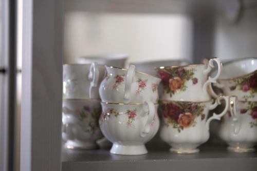 a group of white vases sitting on a shelf at Op d'n Stolberg in Weert