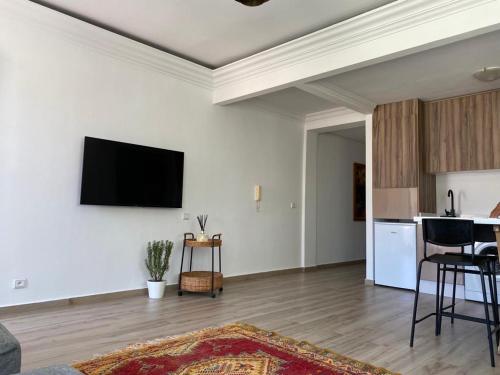 a living room with a flat screen tv on a wall at Appartement 2 chambres salon in Casablanca