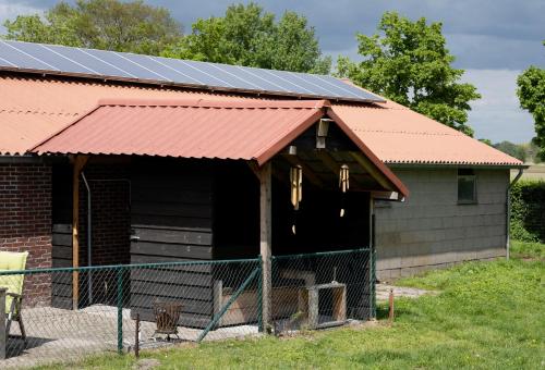 a barn with solar panels on the roof at Op d'n Stolberg in Weert
