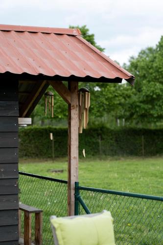 a gazebo with a chair and a table at Op d'n Stolberg in Weert