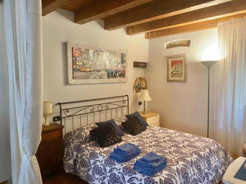 - une chambre avec un lit et des serviettes bleues dans l'établissement Casa sull'Adige, à Vérone