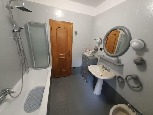 a bathroom with a sink and a mirror at Rendena Dolomiti House CIPAT 022244-AT-012660 in Porte di Rendena