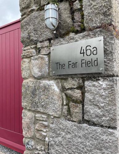 a sign on the side of a stone wall at New build eco house in walled garden, Rostrevor in Rostrevor