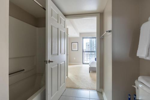 a bathroom with a door leading to a bedroom at Court House 1br w pool gym nr bakeries WDC-783 in Arlington