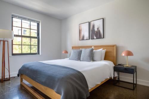 a white bedroom with a large bed and two windows at Uptown 1br w fire pits rooftop nr L red line CHI-979 in Chicago