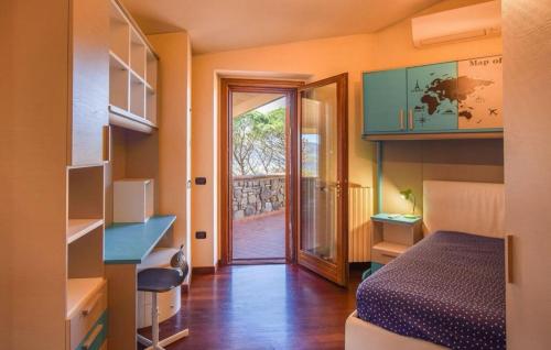 a small room with a bed and a door to a hallway at Villa Paradiso by PosarelliVillas in Nestore