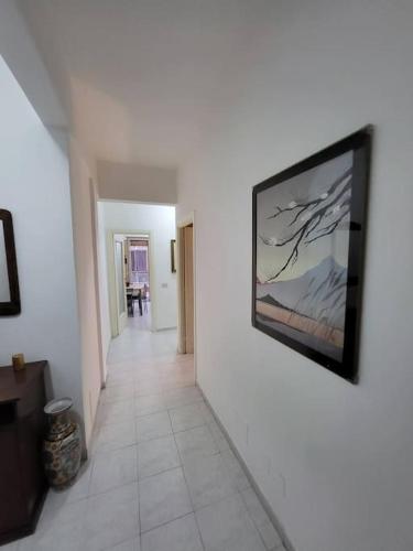 a hallway with a painting on a wall at Happy Ladispoli - Vista Mare in Ladispoli