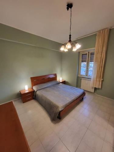 a bedroom with a large bed and two night stands at Happy Ladispoli - Vista Mare in Ladispoli