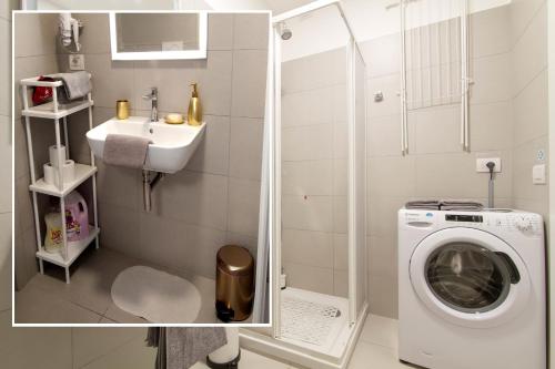 a bathroom with a washing machine and a sink at Metro Plaza Apartment -Buenos Aires in Milan