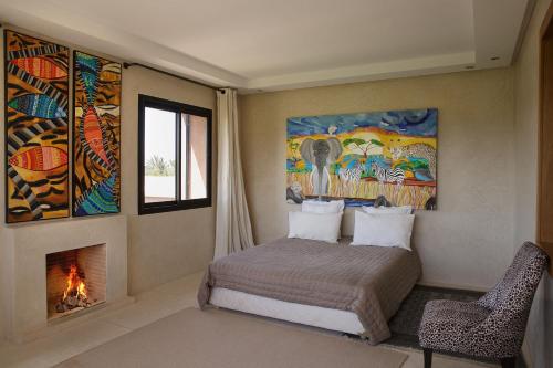 a bedroom with a bed and a fire place at Villa MISH-MISH in Marrakesh