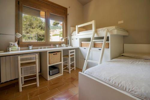 een slaapkamer met een stapelbed en een bureau met een stapelbed bij Begur apartamento in Begur